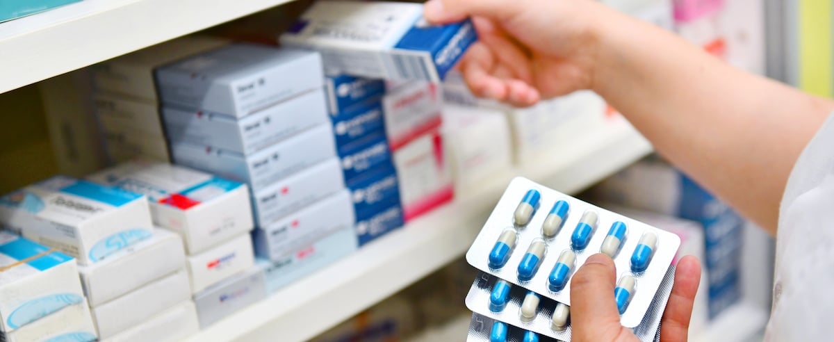 Pharmacist holding medicines box